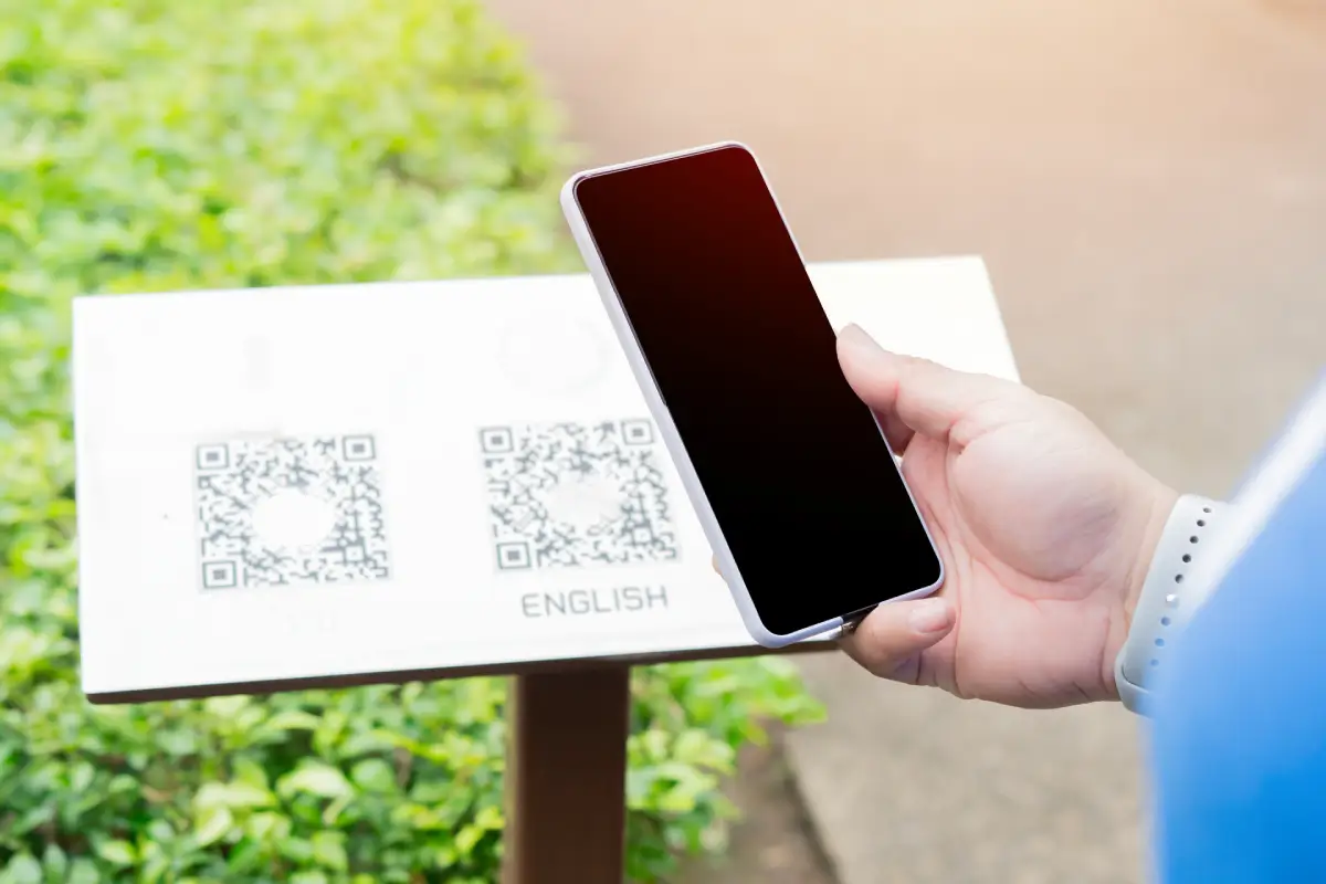Person scanning QR code on outdoor billboard in Egypt with smartphone action